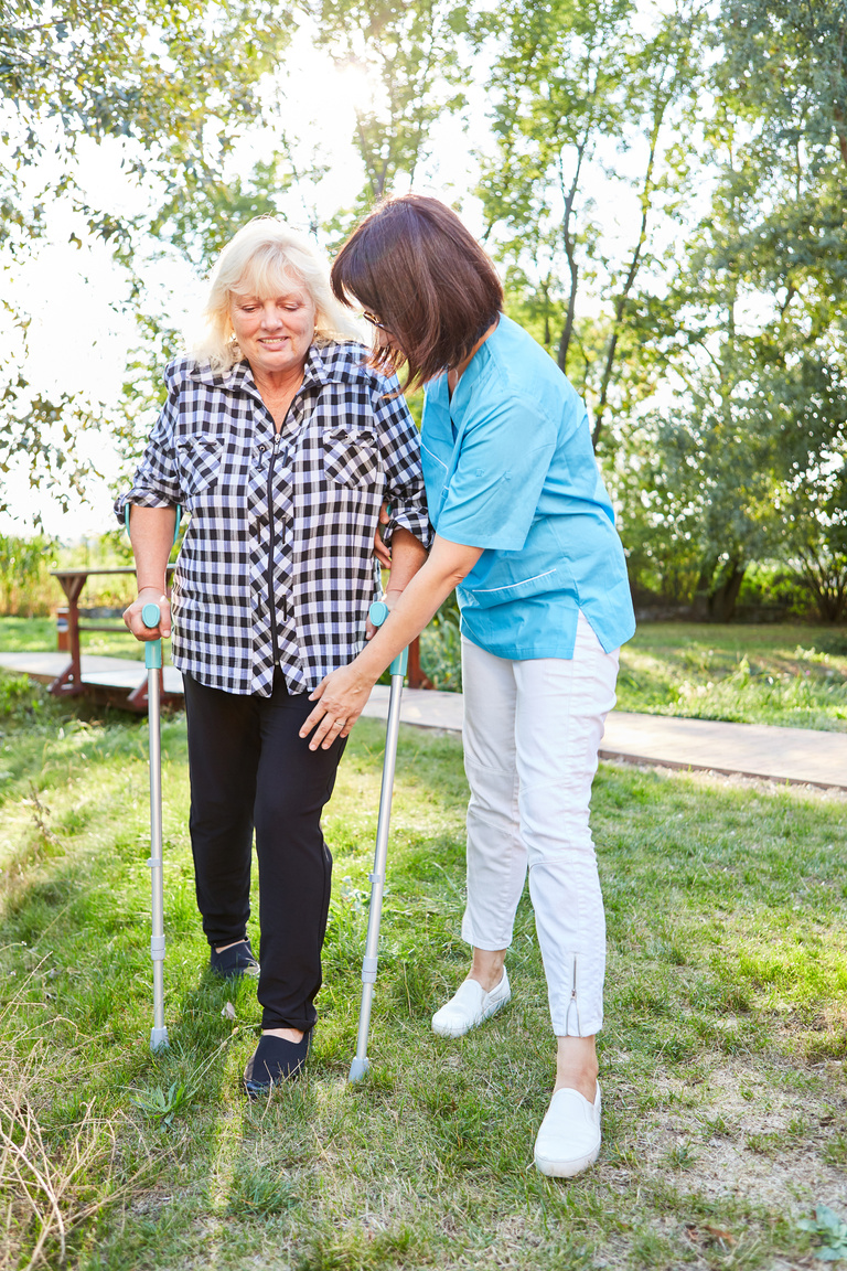 Nursing Woman Helps Senior Woman Learn to Walk